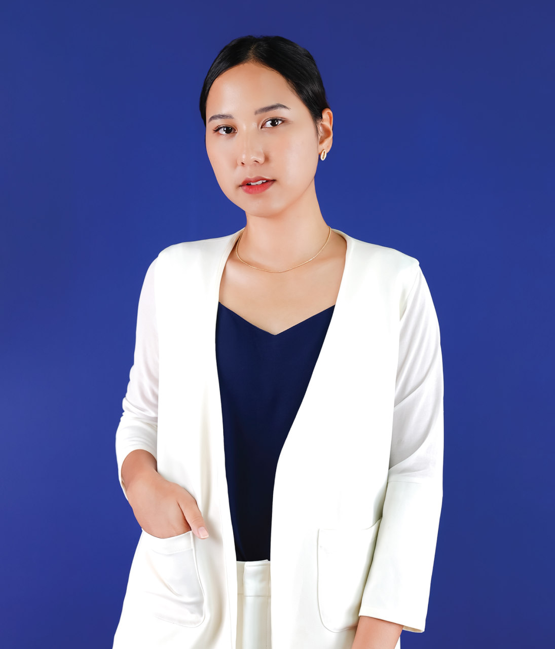 A project manager, working in Marketing Bear, is wearing white blazer and standing hands in pocket